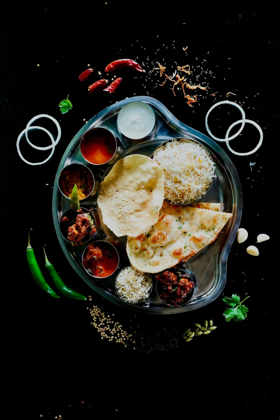 A plate of food on a black table